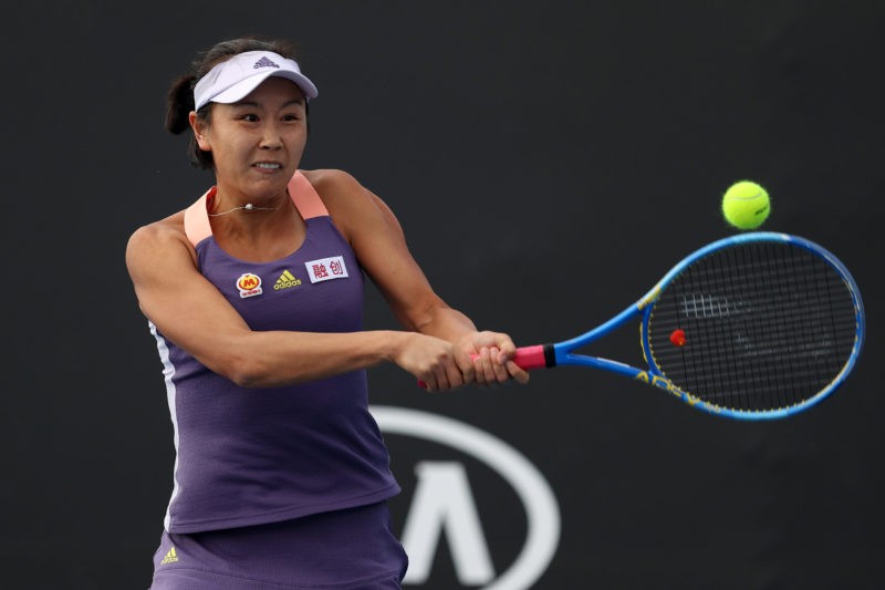 MELBOURNE, AUSTRALIA - JANUARY 23: Shuai Peng of China plays a backhand during her Women's Doubles first round match with partner Shuai Zhang of Ch...