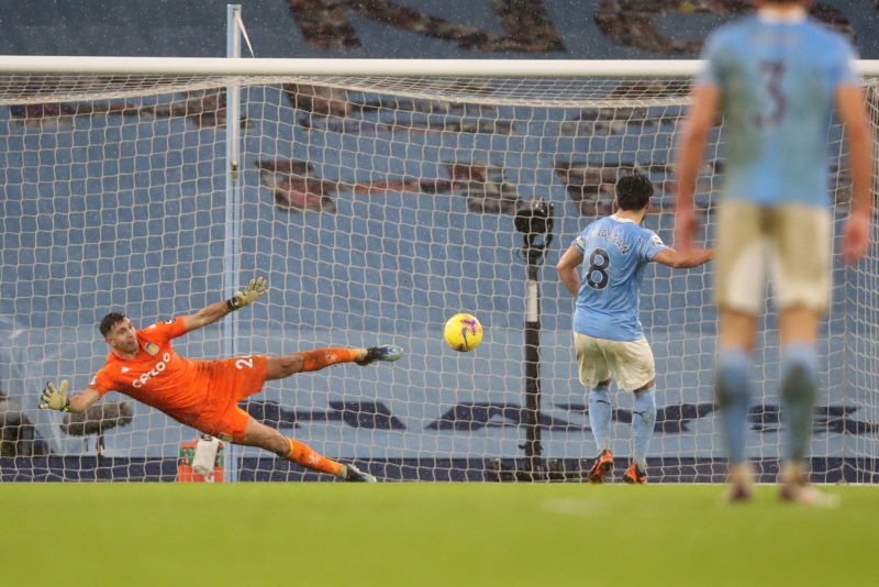 MANCHESTER, ENGLAND - JANUARY 20: Ilkay Gundogan of Manchester City scores their sides second goal past Emi Martinez of Aston Villa from the penalt...