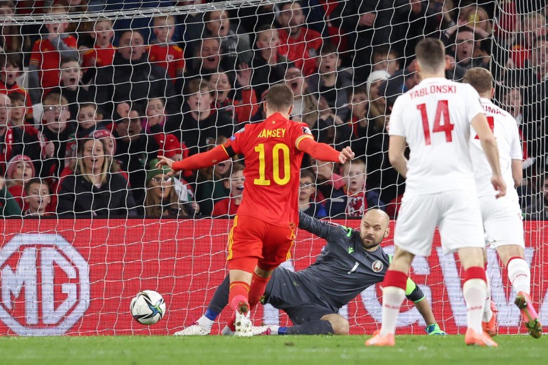 CARDIFF, WALES - NOVEMBER 13: Aaron Ramsey of Wales scores their side's first goal past Sergei Chernik of Belarus during the 2022 FIFA World Cup Qualifier match between Wales and Belarus at Cardiff City Stadium on November 13, 2021 in Cardiff, Wales. (Photo by Richard Heathcote/Getty Images)