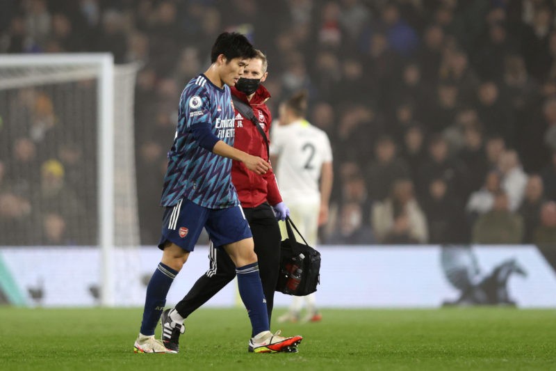 LEEDS, ENGLAND - DECEMBER 18: Takehiro Tomiyasu of Arsenal goes off injured during the Premier League match between Leeds United and Arsenal at Ell...