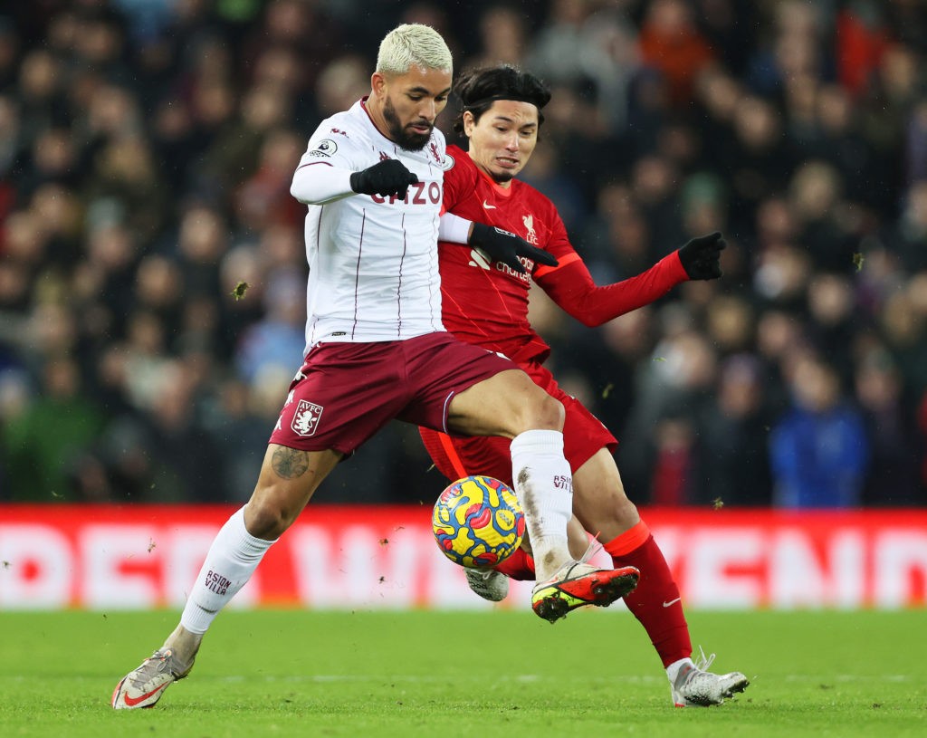 LIVERPOOL, ENGLAND: Douglas Luiz of Aston Villa battles for possession with Takumi Minamino of Liverpool during the Premier League match between Liverpool and Aston Villa at Anfield on December 11, 2021. (Photo by Clive Brunskill / Getty Images)