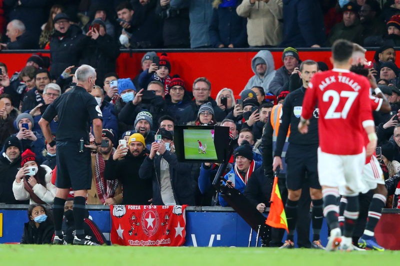 MANCHESTER, ENGLAND - DECEMBER 02: Match Referee, Martin Atkinson checks the VAR monitor before awarding Manchester United a penalty during the Pre...