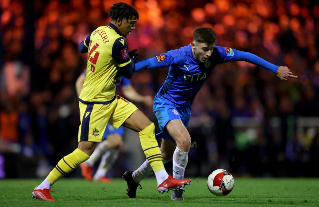 STOCKPORT, ENGLAND: Ryan Rydel of Stockport County is challenged by Xavier Amaechi of Bolton Wanderers during the Emirates FA Cup first round replay between Stockport County and Bolton Wanderers at Edgeley Park on November 17, 2021. (Photo by Alex Livesey / Getty Images)