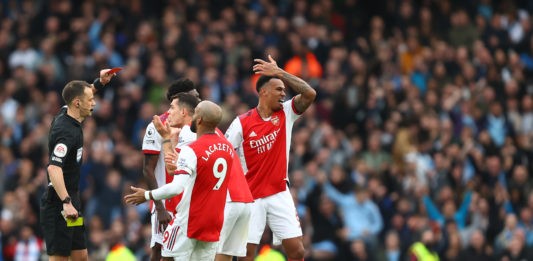 LONDON, ENGLAND: Gabriel Magalhaes of Arsenal is shown a second yellow card leading to a red card by Referee, Stuart Attwell for a foul on Gabriel Jesus of Manchester City during the Premier League match between Arsenal and Manchester City at Emirates Stadium on January 01, 2022. (Photo by Julian Finney / Getty Images)