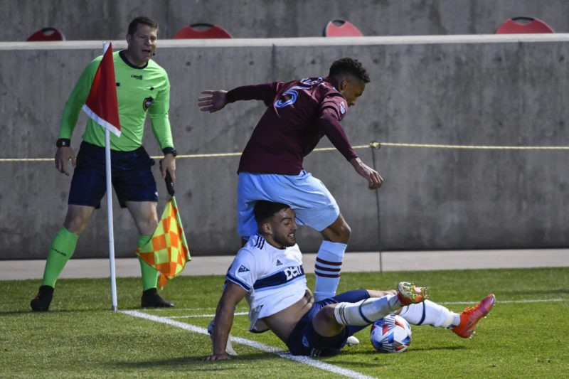 SANDY, UTAH - MAY 02: Lucas Cavallini #9 of Vancouver Whitecaps battles for the ball against Auston Trusty #5 of Colorado Rapids at Rio Tinto Stadi...