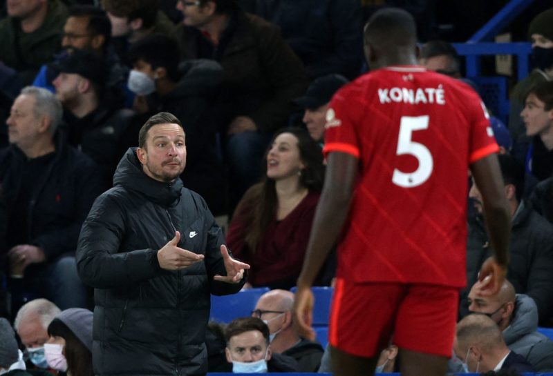 Liverpool's Dutch assistant manager Pepijn Lijnders (L) reacts during the English Premier League football match between Chelsea and Liverpool at St...