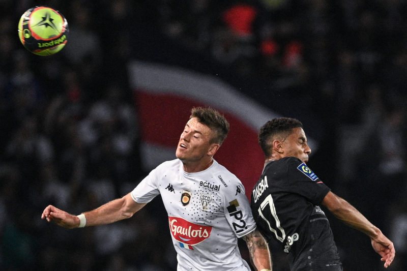Angers' French midfielder Pierrick Capelle (C) and Paris Saint-Germain's French defender Colin Dagba (R) fight for the ball during the French L1 fo...