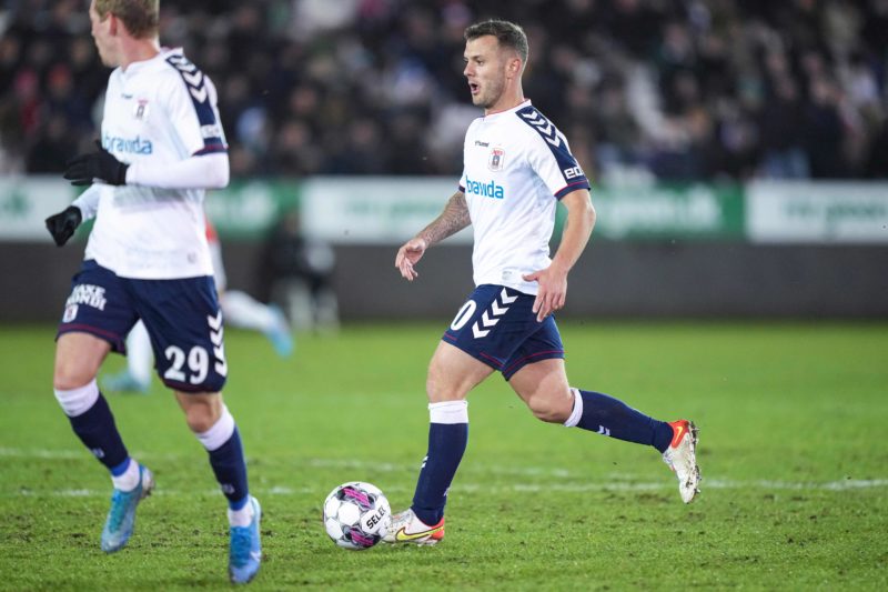 Aarhus' new English midfielder Jack Wilshere (R) runs with the ball during the Danish Superliga match against Vejle at Vejle Stadium on February 25, 2022. - - Denmark OUT (Photo by Claus Fisker / Ritzau Scanpix / AFP) / Denmark OUT (Photo by CLAUS FISKER/Ritzau Scanpix/AFP via Getty Images)