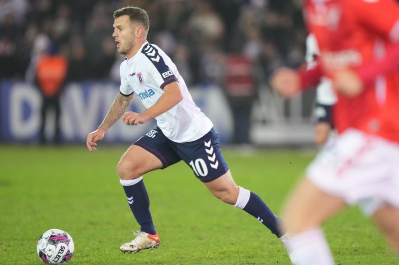 Aarhus' new English midfielder Jack Wilshere (L) runs with the ball during the Danish Superliga match against Vejle at Vejle Stadium on February 25...