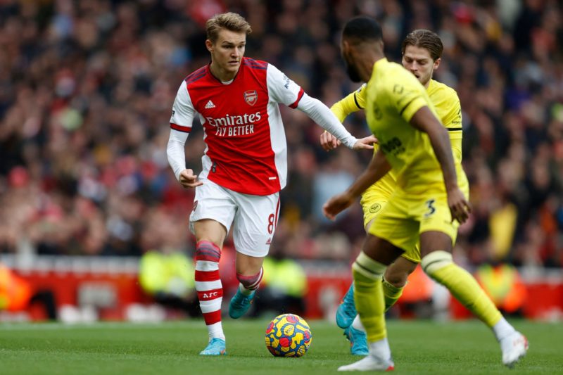 Arsenal's Norwegian midfielder Martin Odegaard runs with the ball during the English Premier League football match between Arsenal and Brentford at...