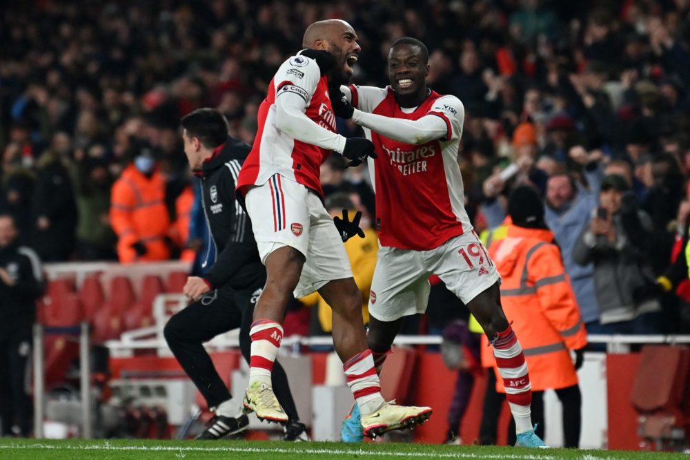 Alexandre Lacazette (L) celebrates with Nicolas Pepe (R) after his shot deflects off Wolverhampton Wanderers' Portuguese goalkeeper Jose Sa (not pi...