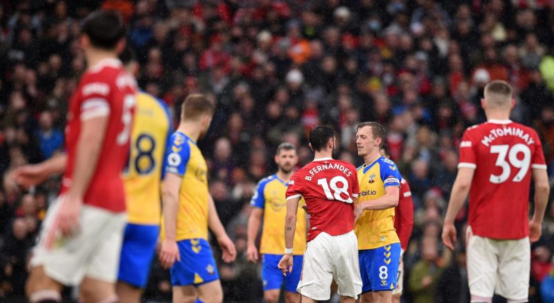 Manchester United's Portuguese midfielder Bruno Fernandes (3R) remonstrates with Southampton's English midfielder James Ward-Prowse (2R) during the...