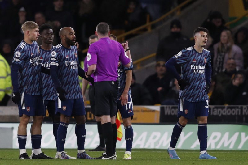 Arsenal's Brazilian striker Gabriel Martinelli (R) walks off having been shown two yellow cards in quick succession by English referee Michael Oliv...