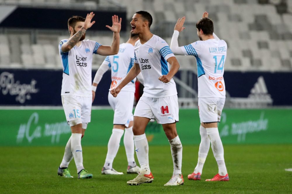 Marseille's French defender William Saliba (C) and teammates celebrate at the end of the French L1 football match between Bordeaux and Marseille on...