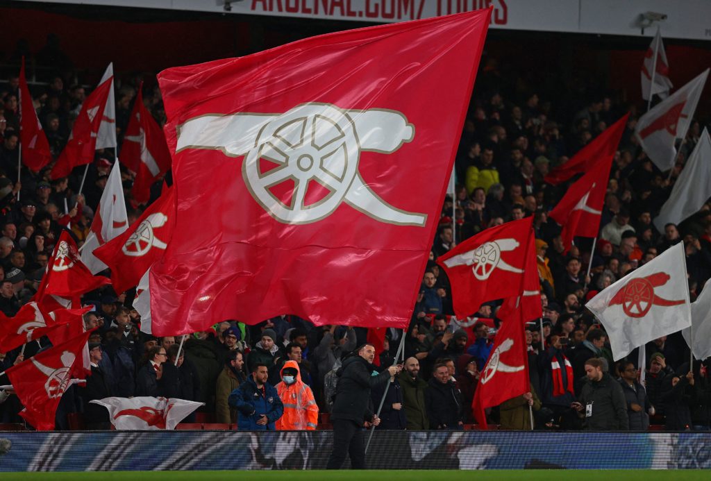 Will Sportsbook make watching Arsenal more exciting? 2 Arsenal fans wave flags ahead of the English Premier League football match between Arsenal and Liverpool at the Emirates Stadium in London on March 16, 2022. (Photo by ADRIAN DENNIS/AFP via Getty Images)