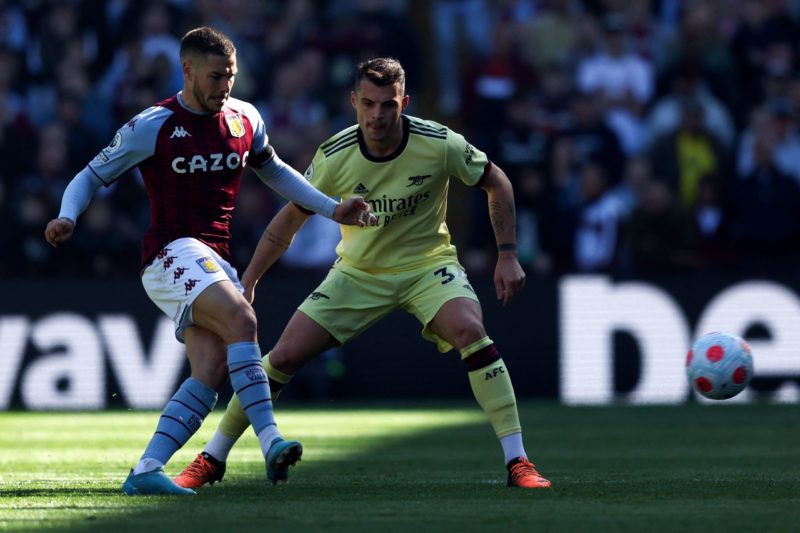 Aston Villa's Argentinian midfielder Emiliano Buendia (L) challenges Arsenal's Swiss midfielder Granit Xhaka during the English Premier League foot...