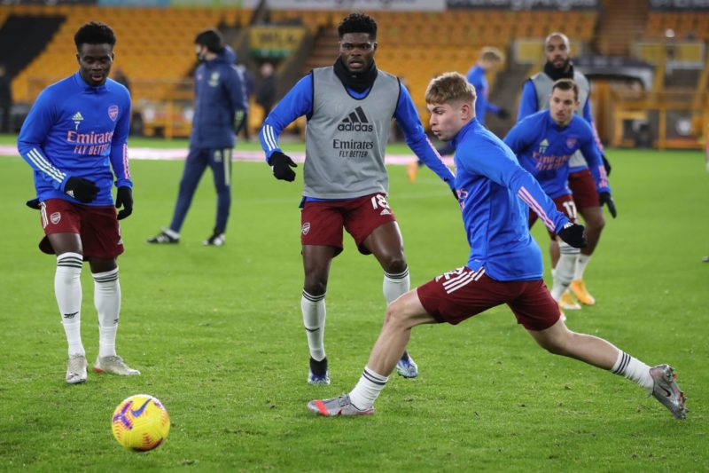Arsenal's English striker Bukayo Saka (L), Arsenal's Ghanaian midfielder Thomas Partey (C) and teammates warm up ahead of the English Premier League football match between Wolverhampton Wanderers and Arsenal at the Molineux stadium in Wolverhampton, central England on February 2, 2021. - 14 (Photo by NICK POTTS/POOL/AFP via Getty Images)