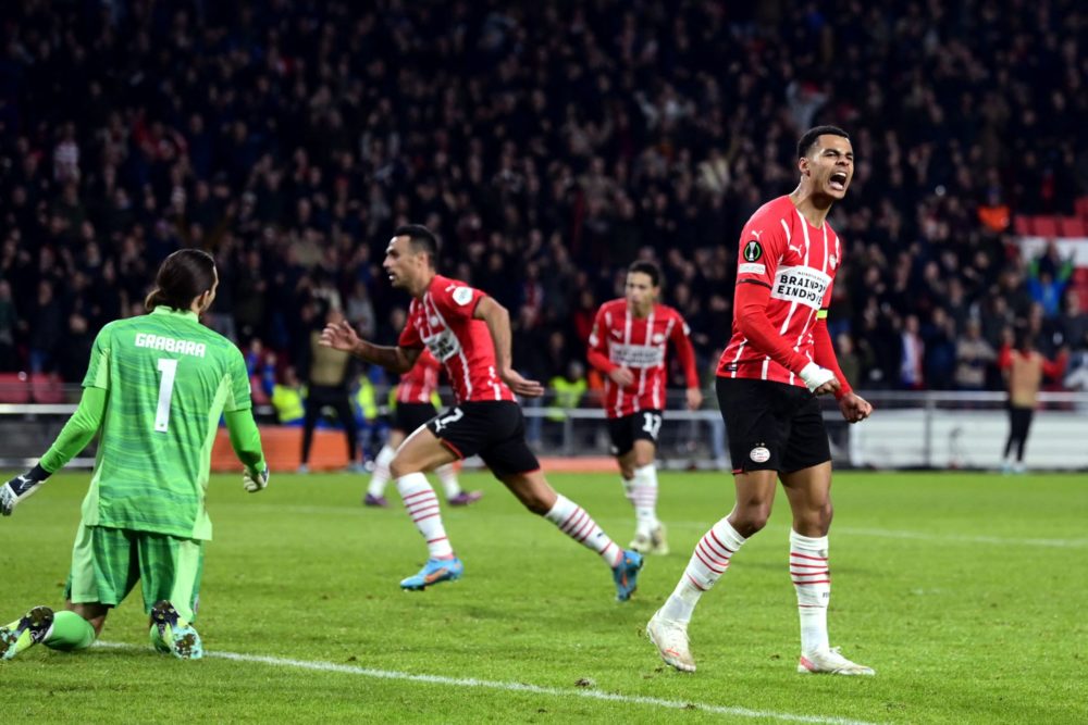 PSV Eindhoven's Dutch Cody Gakpo (R) celebrates at the end of the Europa Conference League football match between PSV and FC Copenhagen at The Phil...