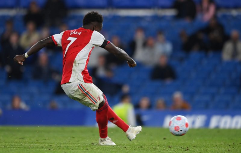 LONDON, ENGLAND - APRIL 20: Bukayo Saka of Arsenal scores their team's fourth goal from the penalty spot during the Premier League match between Ch...