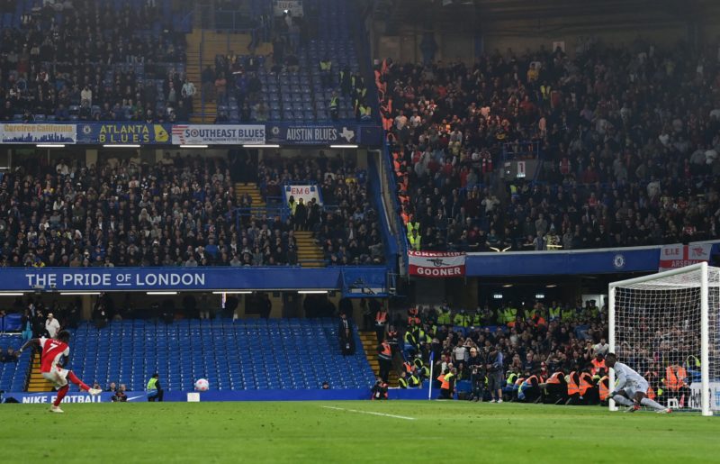 Arsenal's English midfielder Bukayo Saka (L) scores their fourth goal from the penalty spot during the English Premier League football match between Chelsea and Arsenal at Stamford Bridge in London on April 20, 2022.  (Photo by GLYN KIRK/AFP via Getty Images)