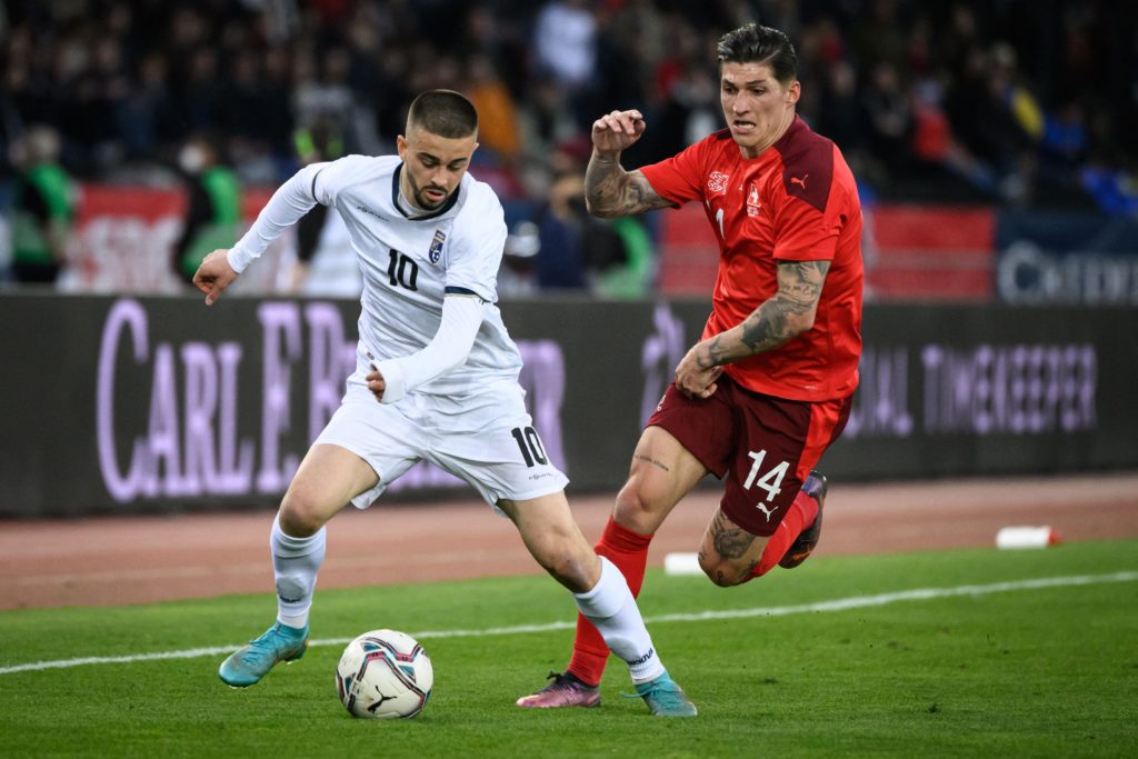 Kosovo's midfielder Edon Zhegrova (L) is challenged by Switzerland's midfielder Steven Zuber during a friendly football match between Switzerland and Kosovo at Stadion Letzigrund stadium in Zurich on March 29, 2022. (Photo by FABRICE COFFRINI/AFP via Getty Images)