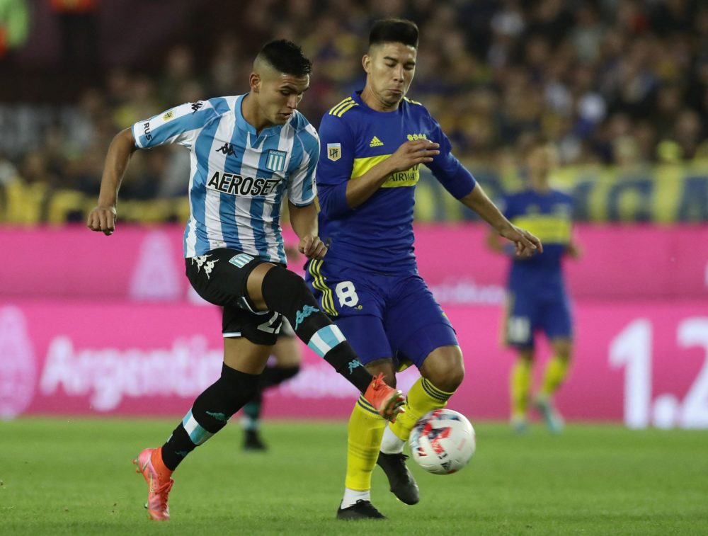 Racing Club's midfielder Carlos Alcaraz (L) vies for the ball with Boca Juniors' midfielder Guillermo Fernandez during their Argentine Professional...
