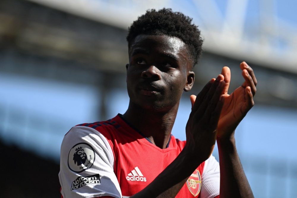 Arsenal's English midfielder Bukayo Saka applauds supporters as he leaves having been substituted during the English Premier League football match ...