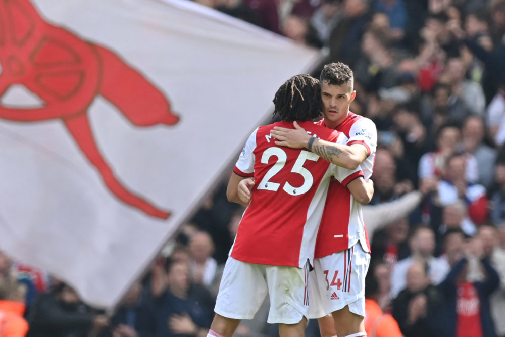 Who is Arsenal's longest serving player? 3 Arsenal's Swiss midfielder Granit Xhaka (R) embraces Arsenal's Egyptian midfielder Mohamed Elneny as they celebrate on the pitch after the English Premier League football match between Arsenal and Manchester United at the Emirates Stadium in London on April 23, 2022. (Photo by GLYN KIRK/AFP via Getty Images)