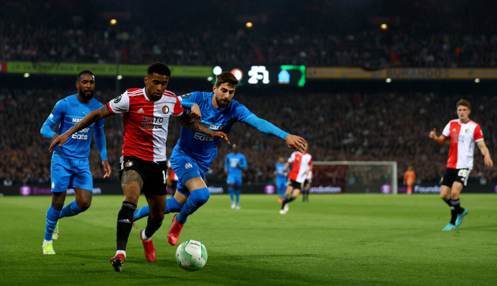 ROTTERDAM, NETHERLANDS: Reiss Nelson of Feyenoord is challenged by Luan Peres of Marseille during the UEFA Conference League Semi-Final Leg One mat...
