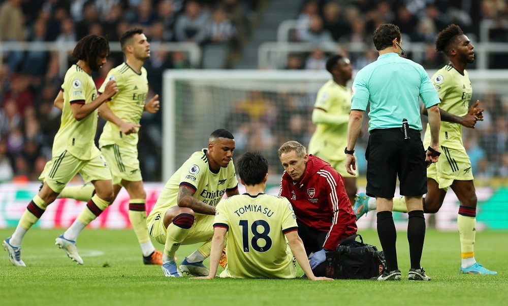 NEWCASTLE UPON TYNE, ENGLAND: Takehiro Tomiyasu of Arsenal receives medical treatment during the Premier League match between Newcastle United and ...