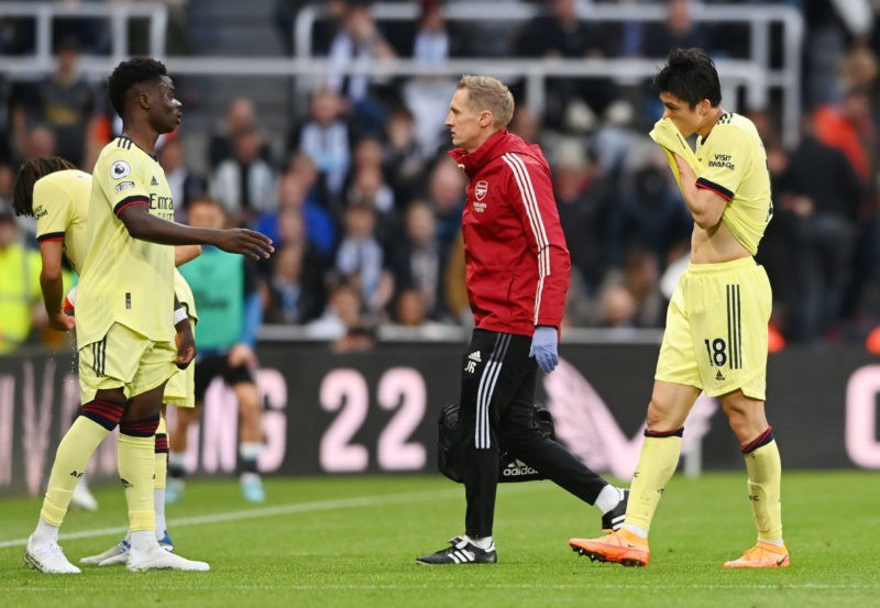NEWCASTLE UPON TYNE, ENGLAND - MAY 16: Takehiro Tomiyasu of Arsenal (R) is substituted off following an injury during the Premier League match betw...