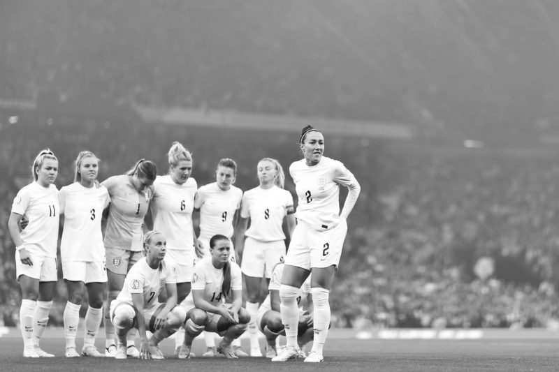 MANCHESTER, ENGLAND - JULY 06: Lucy Bronze of England looks on as England pose for a team photo during the UEFA Women's Euro England 2022 group A m...