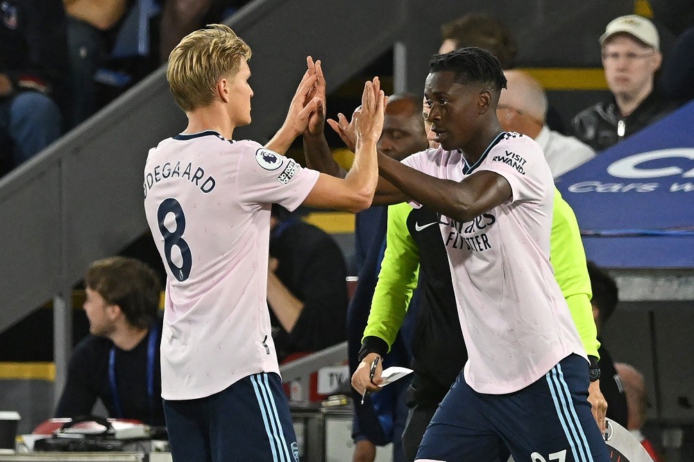 Arsenal's Belgian midfielder Albert Sambi Lokonga (R) comes on for Arsenal's Norwegian midfielder Martin Odegaard (L) during the English Premier Le...