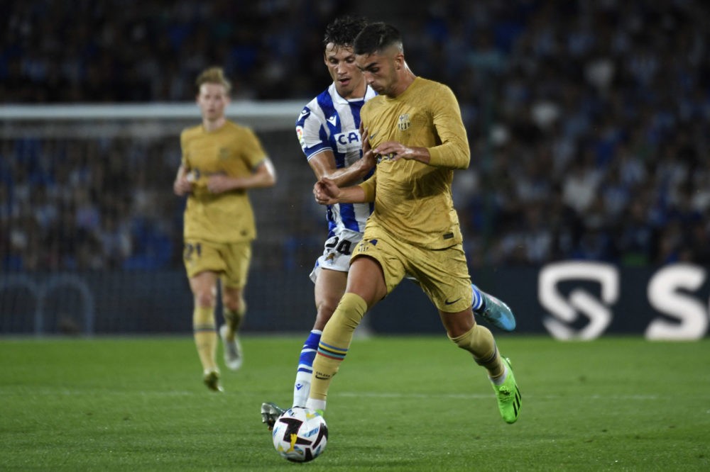Barcelona's Spanish forward Ferran Torres (R) vies with Real Sociedad's French defender Robin Le Normand during the Spanish League football match b...
