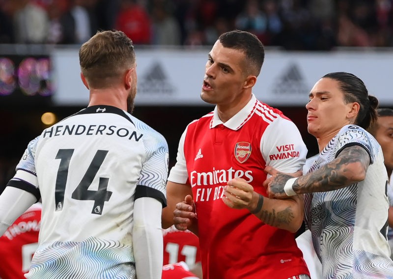 LONDON, ENGLAND - OCTOBER 09: Jordan Henderson of Liverpool clashes with Granit Xhaka of Arsenal after a penalty was given to Arsenal during the Pr...