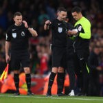 LONDON, ENGLAND - OCTOBER 09: Referee Michael Oliver speaks to fourth official Andy Madley during the Premier League match between Arsenal FC and Liverpool FC at Emirates Stadium on October 09, 2022 in London, England. (Photo by Shaun Botterill/Getty Images)