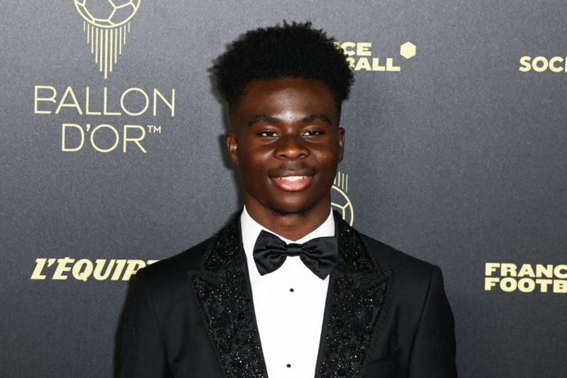 Arsenal's English midfielder Bukayo Saka poses upon arrival to attend the 2022 Ballon d'Or France Football award ceremony at the Theatre du Chatele...