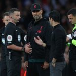 Referee Michael Oliver (2L) speaks to Liverpool's German manager Jurgen Klopp and Arsenal's Spanish manager Mikel Arteta during the English Premier League football match between Arsenal and Liverpool at the Emirates Stadium in London on October 9, 2022. (Photo by ADRIAN DENNIS/AFP via Getty Images)