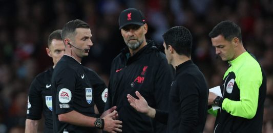 Referee Michael Oliver (2L) speaks to Liverpool's German manager Jurgen Klopp and Arsenal's Spanish manager Mikel Arteta during the English Premier League football match between Arsenal and Liverpool at the Emirates Stadium in London on October 9, 2022. (Photo by ADRIAN DENNIS/AFP via Getty Images)