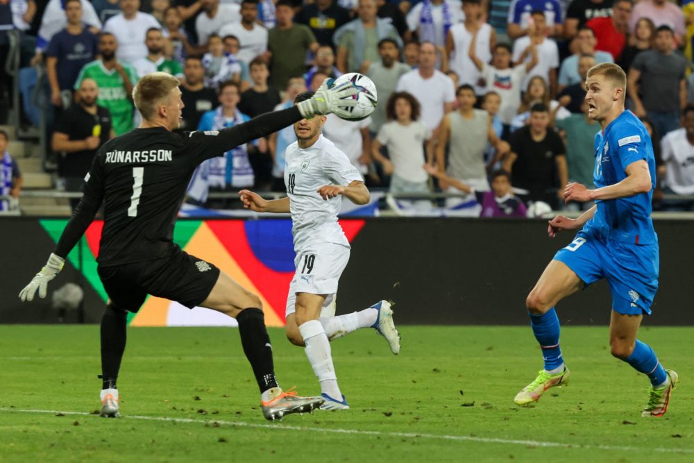 Iceland's goalkeeper Runar Alex Runarsson (L) saves a shot by Israel's forward Liel Abada (C) during the UEFA Nations League football match on June...