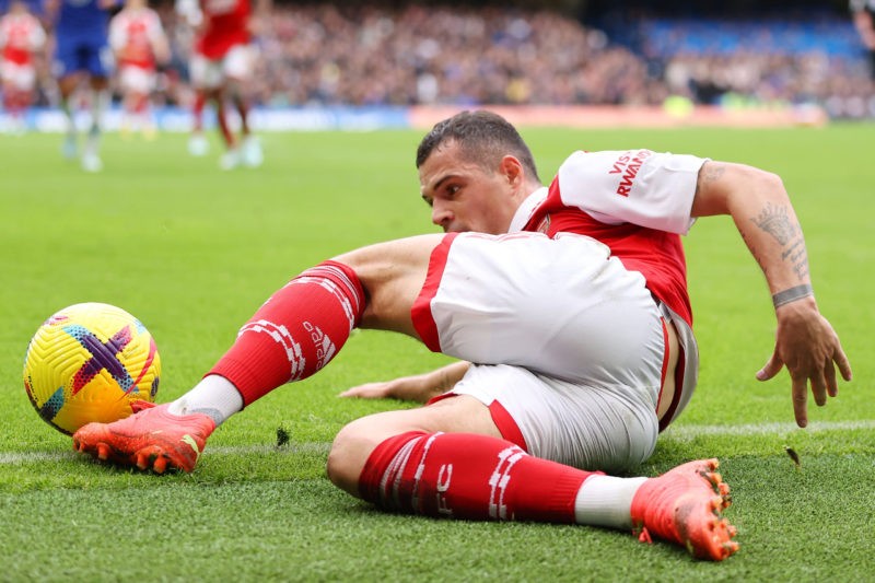 LONDON, ENGLAND - NOVEMBER 06: Granit Xhaka of Arsenal slides for the ball during the Premier League match between Chelsea FC and Arsenal FC at Sta...