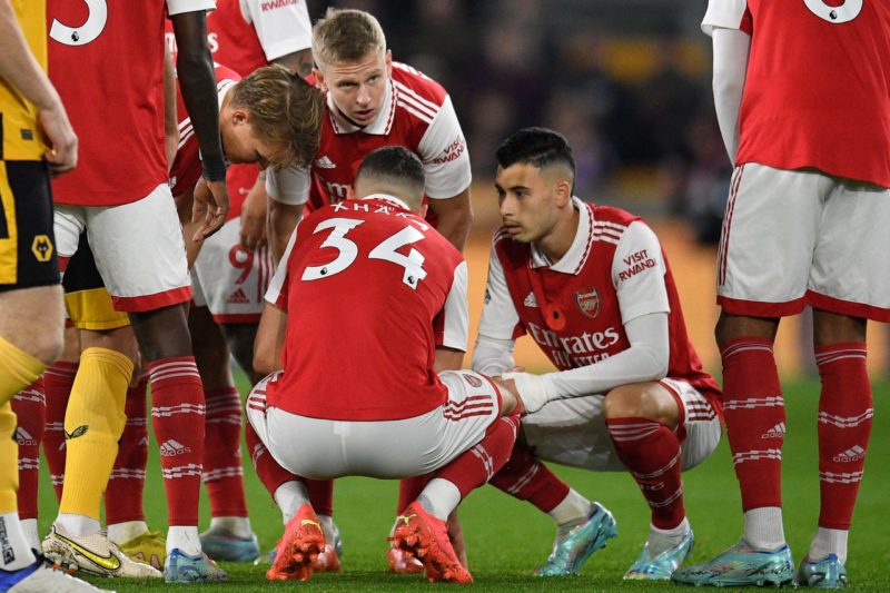 Xhaka & 4 other Arsenal players ill from pre-Wolves meal 2 Arsenal players stand around Arsenal's Swiss midfielder Granit Xhaka during the English Premier League football match between Wolverhampton Wanderers and Arsenal at the Molineux stadium in Wolverhampton, central England on November 12, 2022. (Photo by OLI SCARFF/AFP via Getty Images)