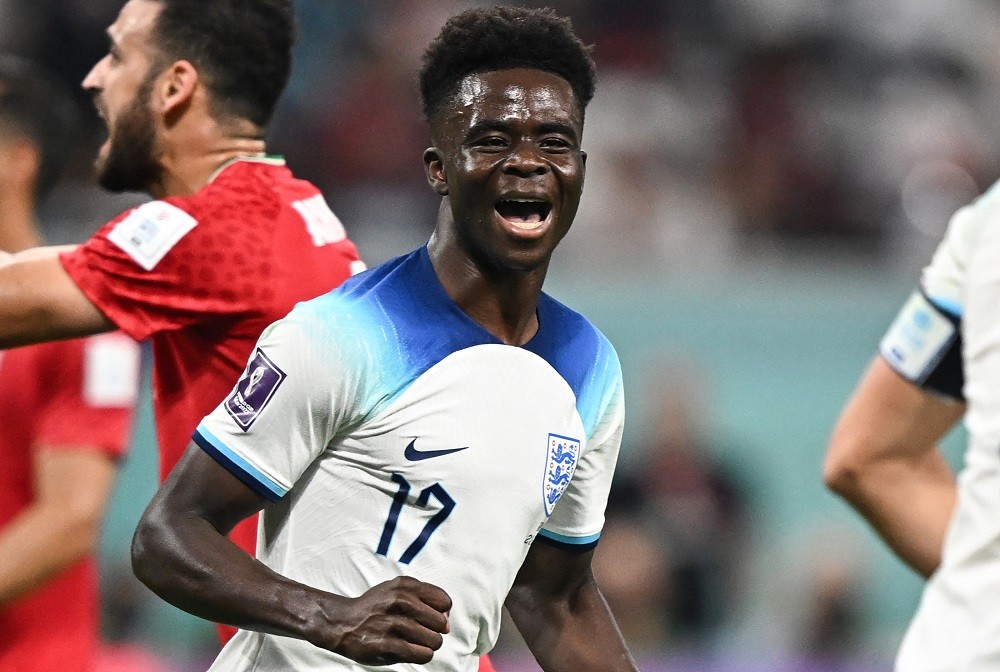 England's Bukayo Saka celebrates scoring his team's fourth goal during the Qatar 2022 World Cup Group B football match between England and Iran at ...