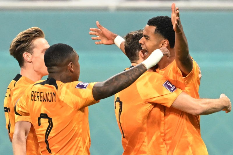 Netherlands' forward #08 Cody Gakpo (R) celebrates scoring his team's first goal during the Qatar 2022 World Cup Group A football match between the...