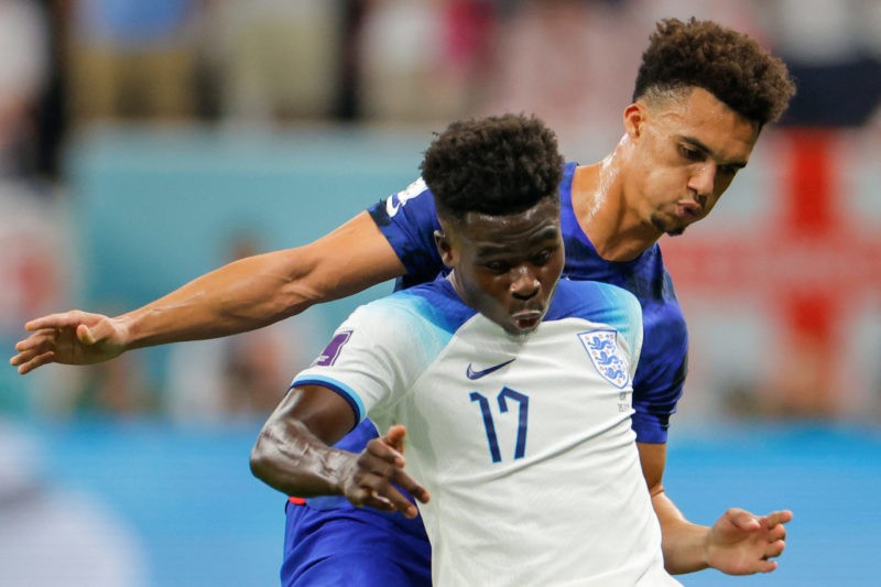 England's forward #17 Bukayo Saka (L) fights for the ball with USA's defender #05 Antonee Robinson during the Qatar 2022 World Cup Group B football...