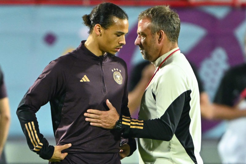 Germany's forward #19 Leroy Sane talks with coach #00 Hans-Dieter Flick during a training session at the Al Shamal Stadium in Al Shamal, north of D...