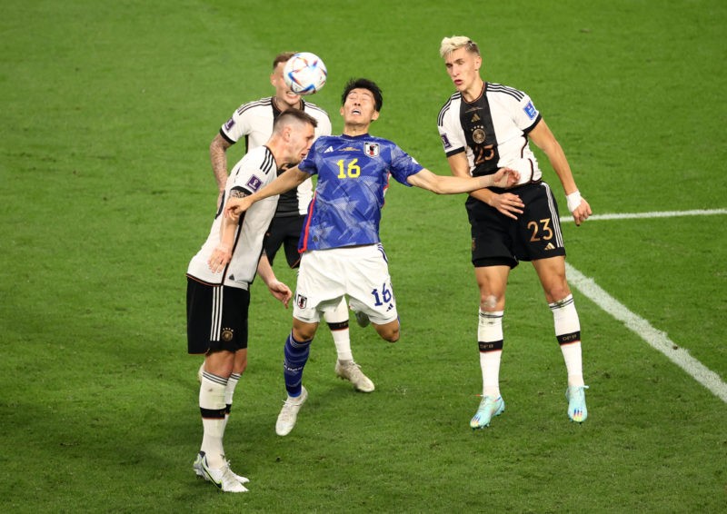 DOHA, QATAR - NOVEMBER 23: Takehiro Tomiyasu of Japan competes for a header against the Germany defence during the FIFA World Cup Qatar 2022 Group ...