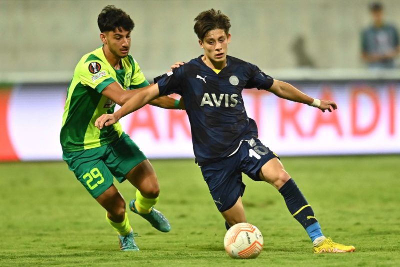 Fenerbahce's Turkish midfielder Arda Guler (R) is marked by AEK Larnaca's Cypriot midfielder Giorgos Naoum during the UEFA Europa League group B fo...
