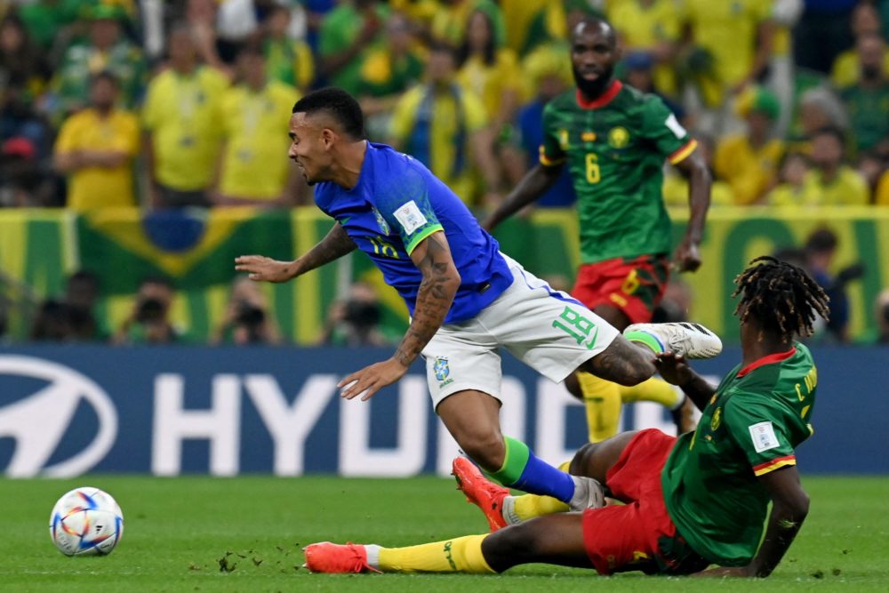 Brazil's forward Gabriel Jesus (L) fights for the ball with Cameroon's defender Christopher Wooh (R) during the Qatar 2022 World Cup Group G football match between Cameroon and Brazil at the Lusail Stadium in Lusail, north of Doha on December 2, 2022. (Photo by ISSOUF SANOGO/AFP via Getty Images)