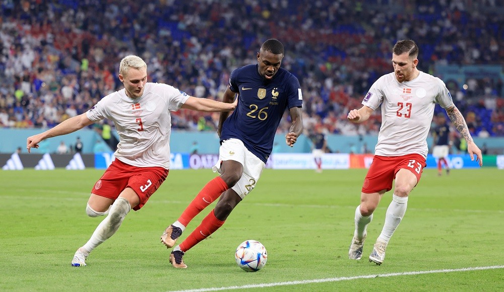 DOHA, QATAR: Marcus Thuram of France controls the ball against Victor Nelsson (L) and Pierre-Emile Hojbjerg of Denmark during the FIFA World Cup Qa...